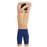 En pojke klädd i badbyxorna sedd bakifrån