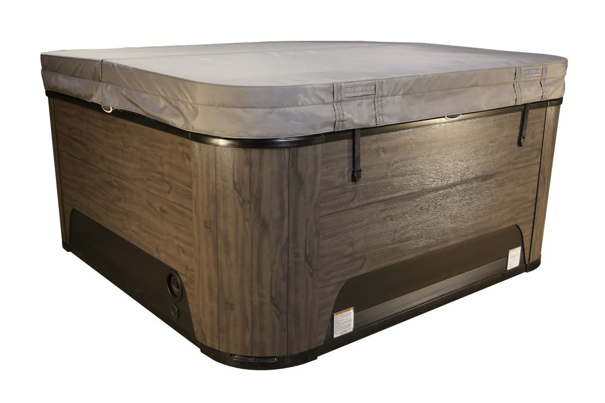 Spabadet med stängt grått lock mot en vit bakgrund