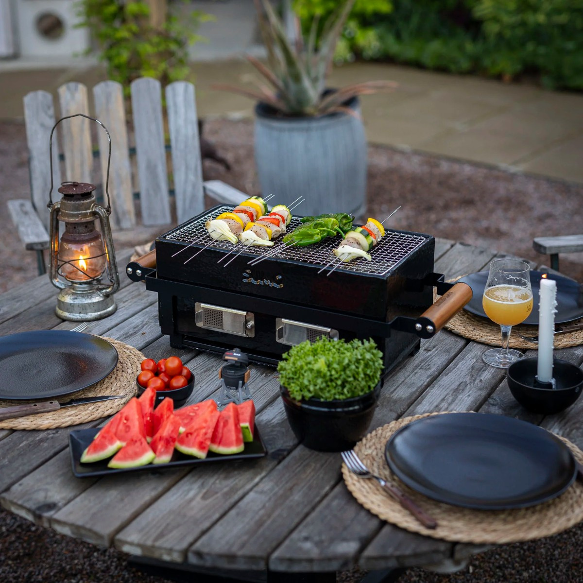 Bordsgrillen på ett dukat bord utomhus