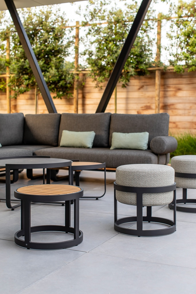 Bordet och två pallar framför en soffgrupp på en uteplats